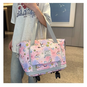 Detail view of pink purple gradient travel bag with cartoon unicorn print and wheels