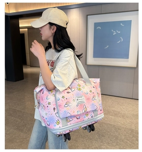 Detail of expandable gradient travel bag with smooth wheels and cute cartoon prints
