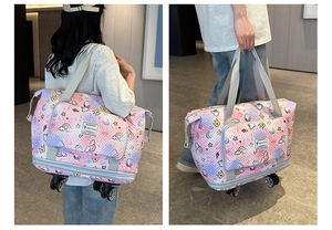 Detail view of the pink and purple gradient travel tote featuring rotating wheels and cartoon prints