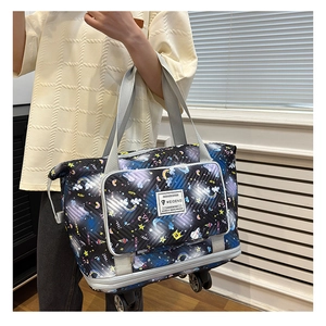 Detail of expandable rolling travel bag featuring colorful unicorn print and smooth wheels