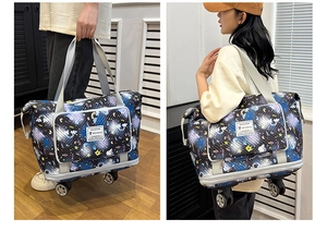 Detail view of large travel bag with rainbow cartoon prints and smooth rolling wheels