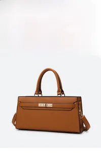 Macro detail of brown litchi pattern leather tote with golden metallic twist lock closure