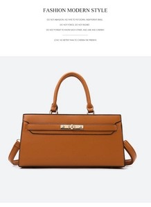 Detail of a brown lychee pattern leather handbag with a golden lock and handle