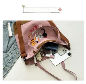 Pink and brown tote bag interior view showing large capacity for tablet and cosmetics