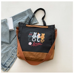 Detail of cute cat printed tote bag with adjustable brown shoulder strap and love text