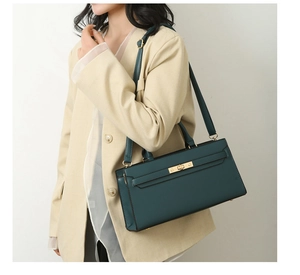 Dark green leather crossbody bag shown on a model highlighting elegant business style