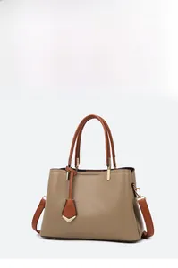 Detail of khaki pebbled leather tote bag with brown contrast straps and gold hardware