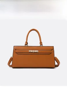 Close-up of caramel brown pebble leather tote bag with gold metal lock and shoulder strap