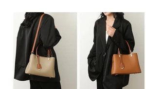Detail view of large tote bags in litchi grain leather with brown handles and shoulder straps