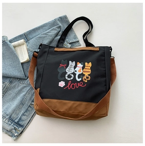 Detail of cute cartoon cat prints on a black and brown large capacity tote bag