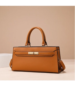 Detail of camel lychee textured leather tote with golden twist lock and hardware