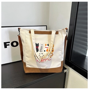 Detail of color-block canvas tote bag with cute cartoon cats print and love text