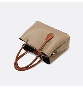 Top view of beige leather handbag showing large capacity compartments and gold hardware