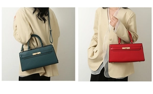 Detail of grained leather tote with golden twist lock and adjustable shoulder strap