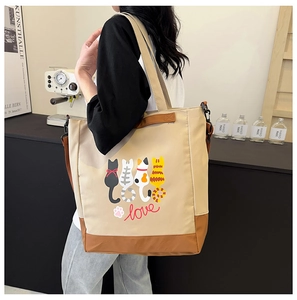 Detailed view of beige cat print canvas tote bag with brown base and adjustable straps