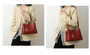 Detailed view of a red leather handbag with gold V-pendant and shoulder strap shown by model