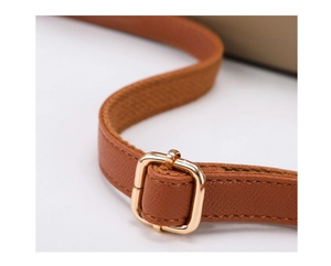 Adjustable caramel brown cross-grain leather shoulder strap with gold metal buckle