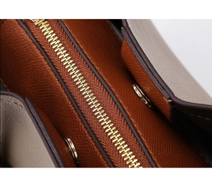 Detail of caramel Saffiano leather with golden zipper and magnetic closure