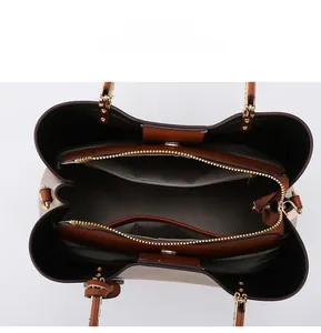 Internal view of the multi-compartment tote bag with three sections and gold hardware