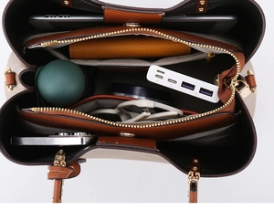 Top view of large capacity tote bag interior with multiple compartments and daily items
