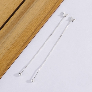 Detailed close-up of butterfly long tassel ear threads in polished silver finish