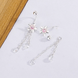 Detailed view of silver cherry blossom earrings with pink zircon and double chain tassels