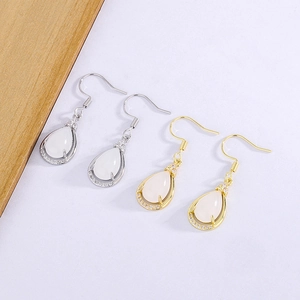 Detail of teardrop chalcedony earrings in silver and gold with micro-pave crystals