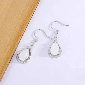 Detail view of silver water drop chalcedony earrings with sparkling zircon accents