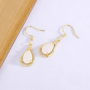 Detailed view of silver-plated teardrop earrings with white chalcedony and zircon accents