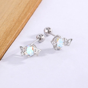 Macro shot of silver butterfly screw back stud earrings with iridescent opal stones