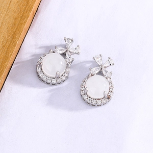 Detail of bow earrings with white chalcedony and cubic zirconia in S925 sterling silver