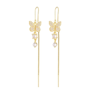 Detail of long gold tassel earrings featuring micro-pave butterfly and sparkling crystals