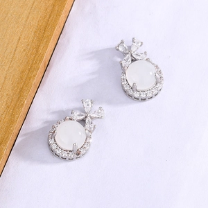 Elegant bow stud earrings featuring white chalcedony and cubic zirconia in silver