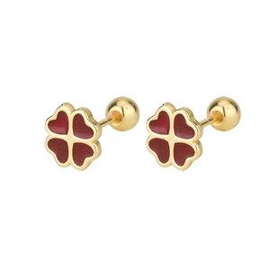Macro view of gold four-leaf clover earrings with red heart petals and secure screw backs