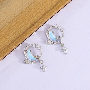 Detail of S925 silver moon and star earrings with blue crystals and zircon stones