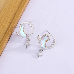 Close-up of S925 silver moon and star studs with iridescent opal-like stones