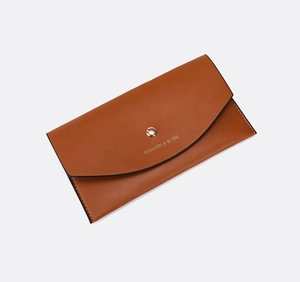 Close-up of brown faux leather envelope wallet with golden snap and FASHION & BAGS logo