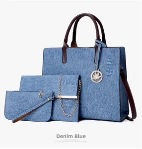 Three-piece denim tote bag set in blue including clutch and chain envelope bag