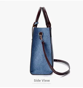 Side view of denim tote bag with brown leather trim and adjustable shoulder strap