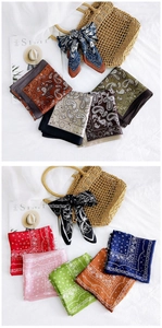 Close-up of silk-textured paisley and floral scarves with a elegant satin finish and rich colors