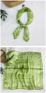 Detail of green square scarf with white paisley patterns for summer styling