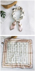 Detailed view of square silk scarf with horsebit chain print and pink border