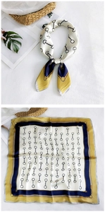 Detail of silk square scarf with vintage horsebit pattern and elegant tri-color border