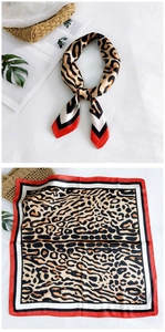 Detail of silk square scarf featuring leopard print with red and black geometric border