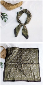 Detail of olive green paisley silk scarf with satin finish and contrast border