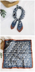 Detail of paisley silk scarf with astronomical patterns shown tied and flat on white fabric
