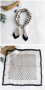 Detail of silk square scarf featuring geometric patterns and satin finish for women