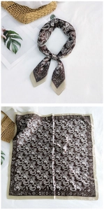 Detailed view of a brown paisley silk scarf showing the tied knot and full square pattern