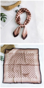 Detail of silk square scarf featuring warm brown geometric paisley patterns and texture