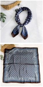 Detail of square silk scarf with navy geometric patterns and vintage ethnic prints